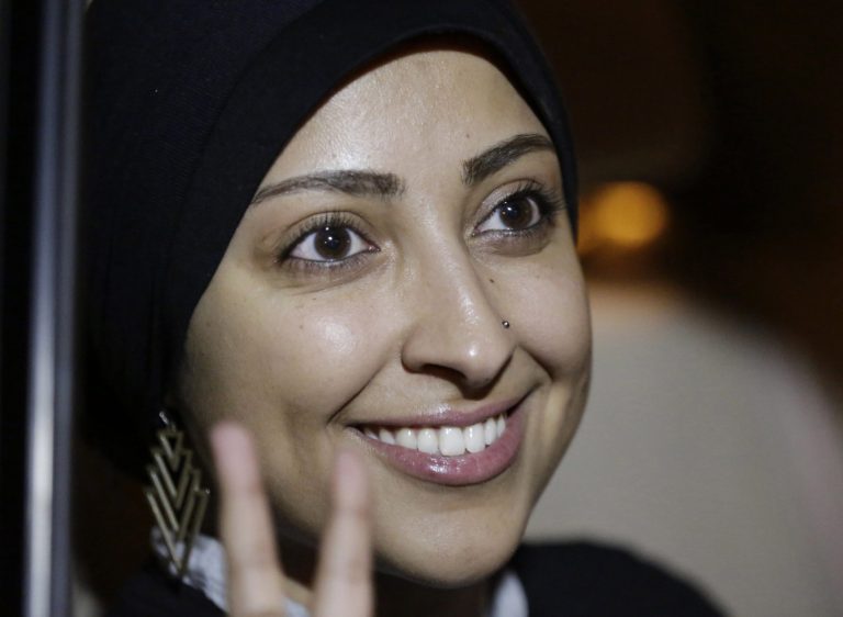 Human rights activist Maryam al-Khawaja flashes the victory sign outside a police station in Muharraq, Bahrain, Thursday, Sept. 18, 2014. Bahrain's Interior Ministry said Thursday that police have released human rights activist Maryam al-Khawaja, who was being held for questioning after her arrest on arrival in the Gulf Arab country last month. (AP Photo/Hasan Jamali)