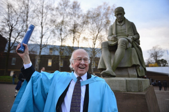 EDINBURGH, SCOTLAND - NOVEMBER 16: Professor Peter Higgs, poses for photographs in front of a statue of James Watt after receiving an honorary degree of doctor of science, from Heriot-Watt University on November 16, 2012 in Edinburgh, Scotland. Professor Peter Higgs, the scientist who postulated and gave his name to the recently discovered Higgs boson, the so called god particle, received the degree in recognition of his pioneering and greatly influential contribution to physics.(Photo by Jeff J Mitchell/Getty Images)