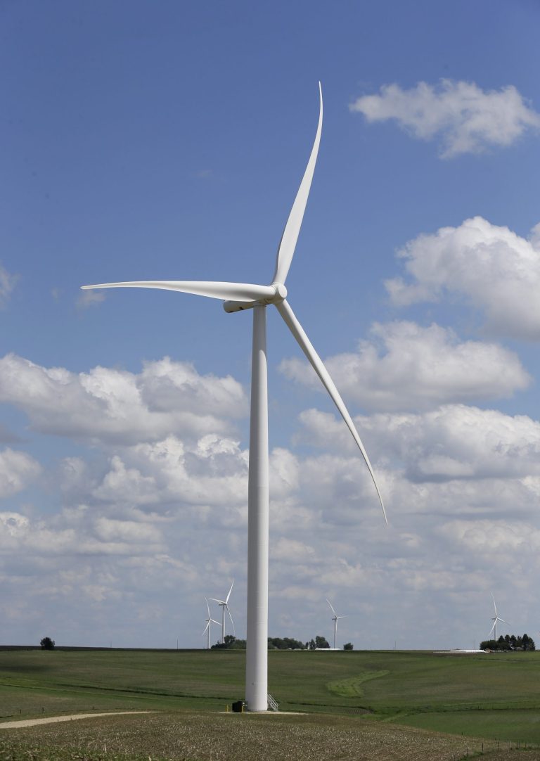 A wind turbine stands  in a field, Monday, June 2, 2014, in Adair, Iowa. Iowa utility officials say the Obama administration's ambitious plan to cut carbon dioxide emissions from power plants is likely to increase costs. (AP Photo/Charlie Neibergall)