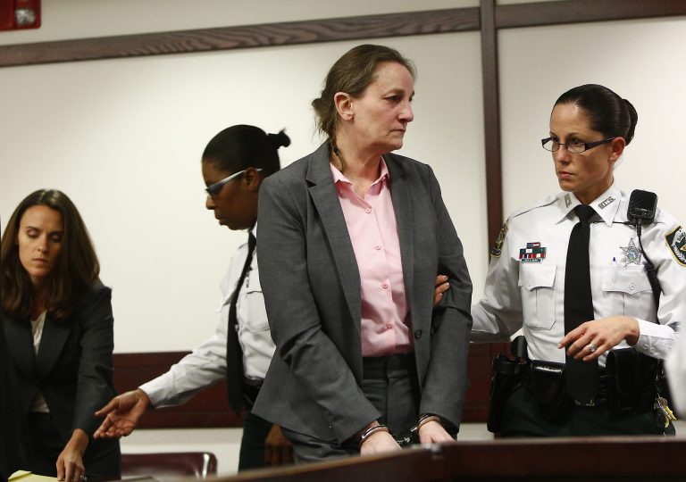 Julie Schenecker looks at her family members as she is escorted out of the courtroom after being found guilty of two counts of first-degree murder at the George E. Edgecomb Courthouse, Thursday, May 15, 2014 in Tampa, Fla. Schenecker, 53, is the woman accused of killing her two teenage children Calyx, 16, and Beau, 13, in 2011. (AP Photo/Tampa Bay Times, Lara Cerri, Pool)