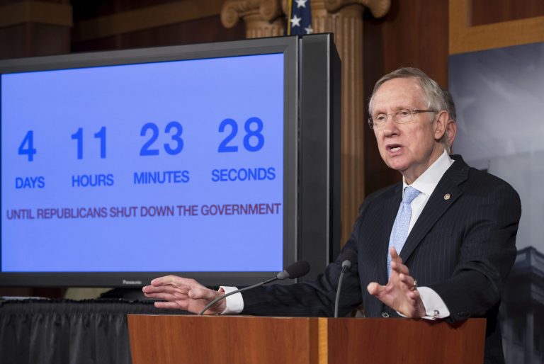 With four days to go before the federal government is due to run out of money, Senate Majority Leader Harry Reid of Nev. speaks next to a countdown clock during a news conference on Capitol Hill in Washington, as Senate Democratic leaders blame conservative Republicans for holding up a stopgap spending bill to keep the government running. (AP/J. Scott Applewhite)