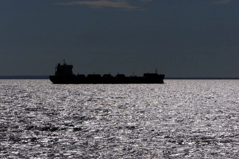 FILE - In this July, 17, 1999, file photo, a freighter is silhouetted on Lake Superior near Whitefish Point, Mich. Two newly completed scientific papers are providing fresh information about how complex interactions of evaporation, precipitation and winter ice cover affect water levels on the Great Lakes, and regional industries such as shipping and tourism. (AP Photo/Carlos Osorio, File)