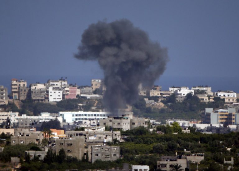 Smoke rises following an Israeli strike on Gaza, seen from the Israel Gaza border on Sunday, July 13, 2014. Israel briefly deployed ground troops inside the Gaza Strip for the first time early Sunday as its military warned northern Gaza residents to evacuate their homes, part of a widening offensive that has killed more than 160 Palestinians. (AP Photo/Lefteris Pitarakis)