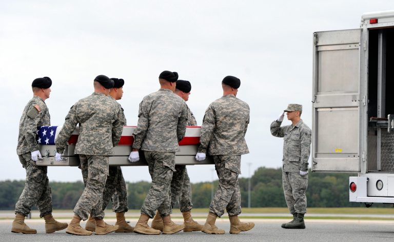 An Army carry team moves a transfer case containing the remains of Pfc. Cody J. Patterson Wednesday, Oct. 9, 2013 at Dover Air Force Base, Del. According to the Department of Defense, Patterson, 24, of Philomath, Ore., died Oct. 6, 2013 in Zhari district, Afghanistan of injuries sustained when enemy forces attacked his unit with an improvised explosive device. (AP Photo/Steve Ruark)
