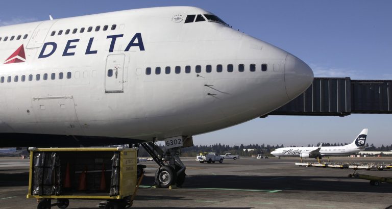FILE - In this Oct. 8, 2012 file photo, a Delta Air Lines airplane is parked at Seattle-Tacoma International Airport in Seattle. Delta reports quarterly earnings on Wednesday, April 23, 2014. (AP Photo/Ted S. Warren File)