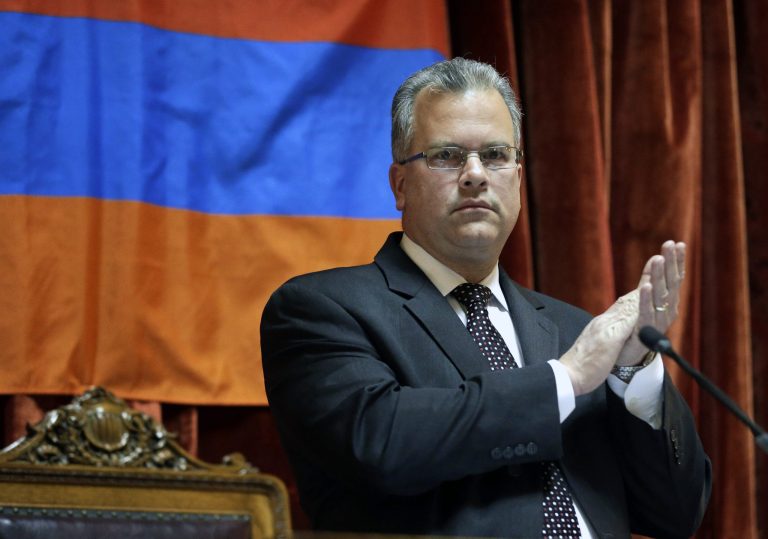 In this April 30, 2014 photo, Rhode Island House Speaker Nicholas Mattiello, applauds as guests are introduced during a recess on the floor of the House Chamber at the Statehouse, in Providence, R.I. Mattiello is a centrist Democrat and former majority leader whose meteoric rise to the position followed the downfall of Gordon Fox. (AP Photo/Steven Senne)