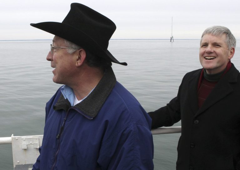   FILE - In this Feb. 2, 2010 file photo, Secretary of the Interior, Ken Salazar, left. and Deputy Secretary of the Interior David Hayes, take in the view aboard the U.S. Coast Guard's Ida Lewis buoy tender while on an information gathering tour of Nantucket Sound regarding the viability of the Cape Wind power project. Behind them is a 190-foot meteorological tower, part of the potential Cape Wind site. Federal Aviation Administration officials felt political pressure to approve the planned wind farm, and did so amid internal disagreements over how to ensure the wind turbines wouldnât interfere with local radar and compromise airplane safety, according to FAA documents obtained by the projectâs opponents. (AP Photo/Julia Cumes, File)  