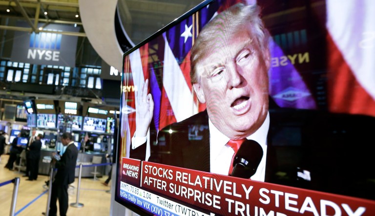 An image of President-elect Donald Trump appears on a television screen on the floor of the New York Stock Exchange, Wednesday, Nov. 9, 2016. (AP Photo/Richard Drew)