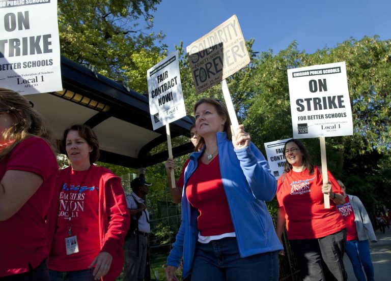 Public school teachers picket outside Amundsen High School on the first day of a strike by the Chicago Teachers Union, Monday, Sept. 10, 2012, in Chicago. The school is one of more than 140 schools in the Chicago Public Schools' 