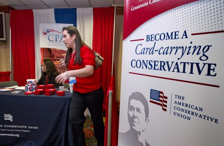 Vendors operate a booth selling memberships in the American Conservative Union Foundation as America's political right gathers for the Conservative Political Action Conference in February.  (AP Photo/J. Scott Applewhite)
