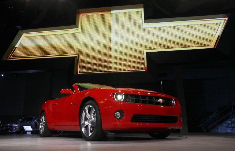 In this Wednesday, Nov. 17, 2010, file photo, the 2011 Chevrolet Camaro convertible debuts at the Los Angeles Auto Show. General Motors is recalling nearly 512,000 Chevrolet Camaro muscle cars from the 2010 to 2014 model years. A driver's knee can bump the key and knock the switch out of the 