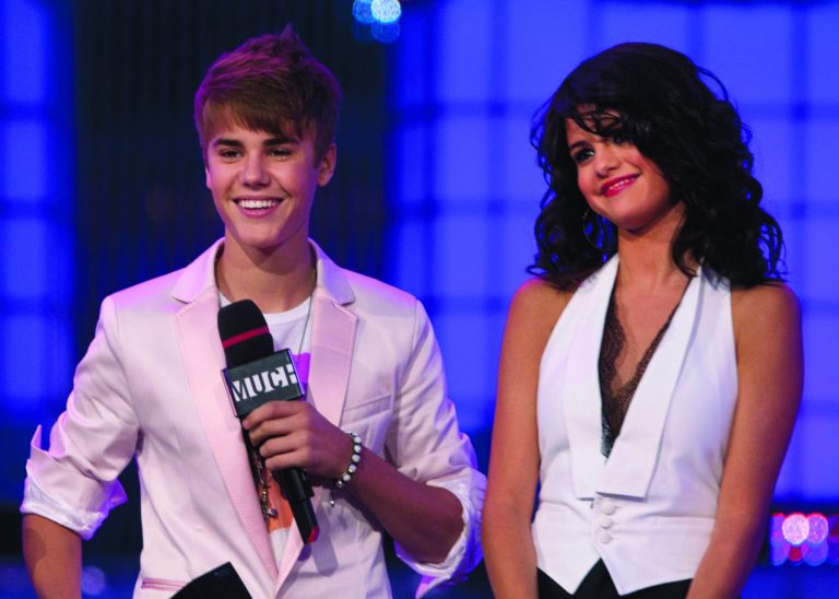 File-This June 19, 2011 file photo shows Justin Bieber and girlfriend Selena Gomez standing on stage during the 2011 MuchMusic Video Awards in Toronto. Bieber is no longer Gomez's 'Boyfriend,' a source confirms to the AP. The split happened last week and distance and their busy schedules were a contributing factor. Eighteen-year-old Bieber is currently touring to promote his album, while 20-year-old Gomez is filming a 