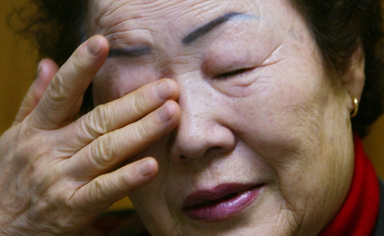FILE - In this Feb. 23, 2007 file photo, Lee Yong-soo wipes her tears as she recalls hardships she experienced during World War II in Tokyo. Lee hopes a meeting Monday, Aug. 18, 2014,  with Pope Francis will provide some solace for the pain that still feels fresh more than seven decades after Japanese soldiers forced her into prostitution during WWII.  (AP Photo/Junji Kurokawa, File)