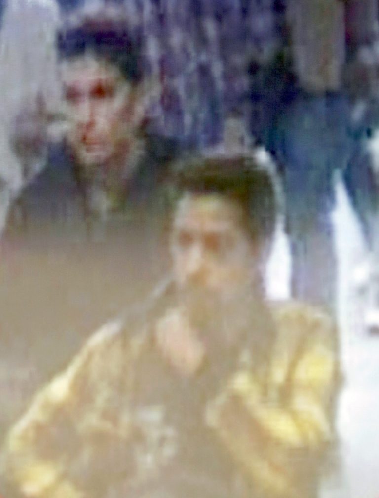 The image of two Iranian who Inetrpol say were traveling with stolen passports on a missing Malaysia Arlines jetliner displayed on a screen during a presser at the Interpol headquarters in Lyon, central France, Tuesday, March 11, 2014.  (AP Photo/Laurent Cipriani)