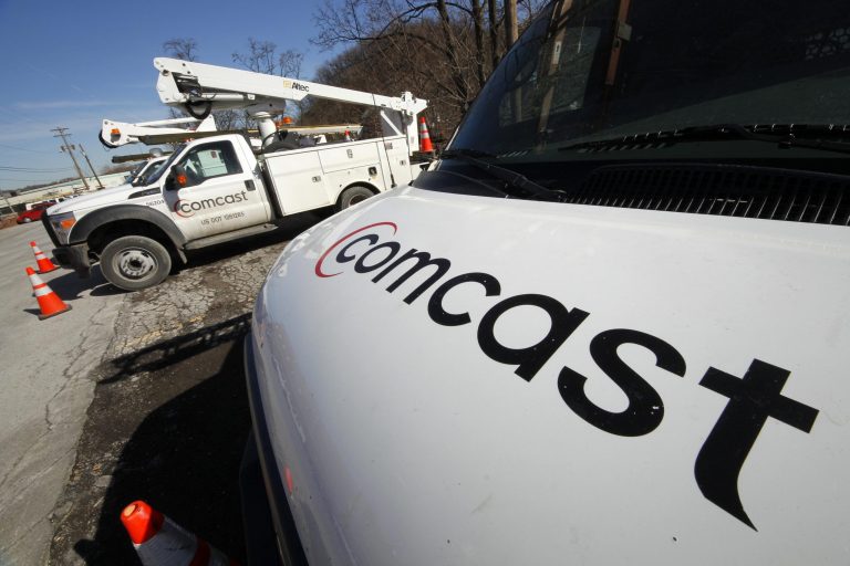 FILE - This Feb. 15, 2011 file photo shows Comcast installation trucks in Pittsburgh. Comcast Corp. reports quarterly financial results before the market opens Tuesday, July 22, 2014. (AP Photo/Gene J. Puskar, File)