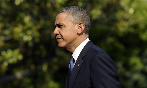 President Barack Obama walks on the South Lawn after returning to the White House in Washington, Sunday, May 19, 2013. Obama delivered the commencement address at Morehouse College earlier in the day in Atlanta. (AP Photo/Susan Walsh)