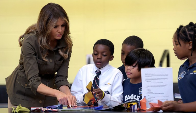 First lady Melania Trump visits with children who are showing her a paper airplane demonstration at a youth center at Andrews Air Force Base in Md., Friday, Sept. 15, 2017. (AP Photo/Susan Walsh)