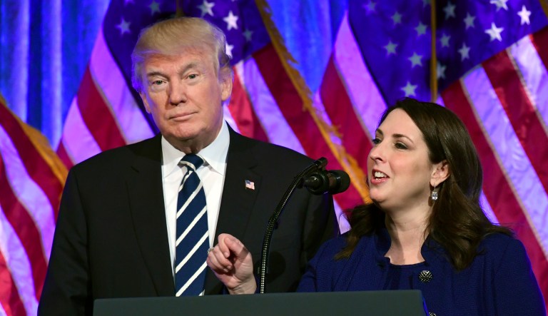 President Trump, left, listens as Republican National Committee chairwoman Ronna Romney McDaniel, right, speaks at a fundraiser at Cipriani in New York, Saturday, Dec. 2, 2017. (AP Photo/Susan Walsh)