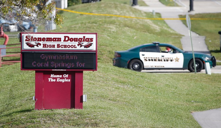 In this photo from Thursday, law enforcement officers block off the entrance to Marjory Stoneman Douglas High School in Parkland, Fla. Nikolas Cruz was charged with 17 counts of premeditated murder on Thursday, the day after he opened fire with a semi-automatic weapon at the school. The Anti-Defamation League also said Republic of Florida leader Jordan Jereb told them that Cruz, 19, was associated with his white supremacist group. (AP Photo/Wilfredo Lee)