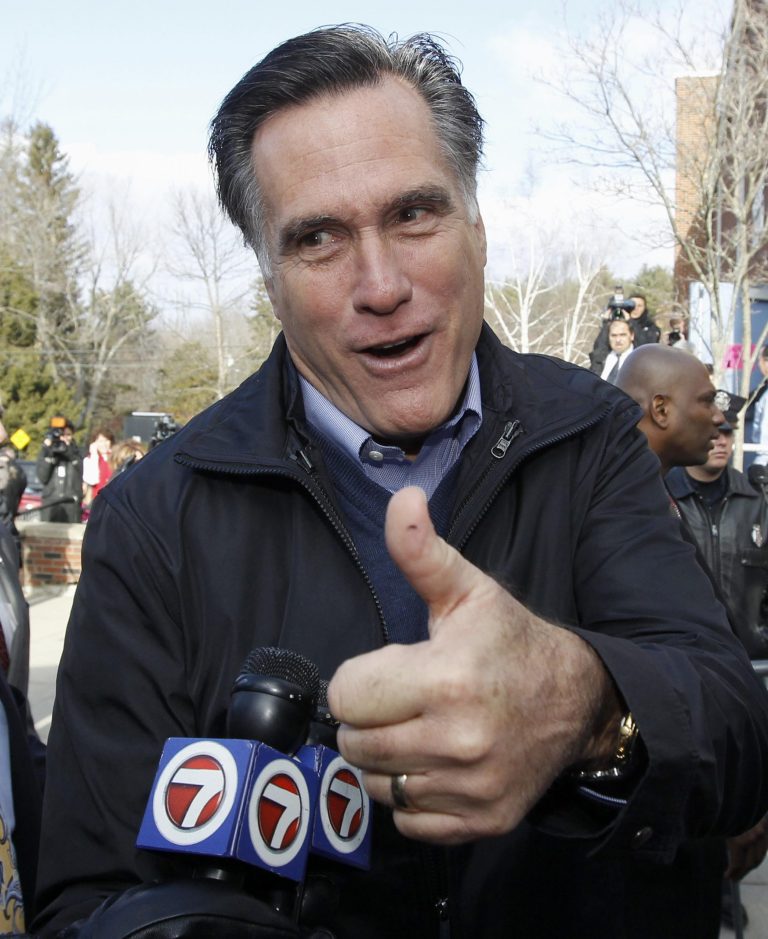 Republican presidential candidate, former Massachusetts Gov. Mitt Romney gives a thumbs up as he campaigns on primary election day outside of a polling station at Webster School in Manchester, N.H., Tuesday, Jan. 10, 2012. (AP Photo/Charles Dharapak)