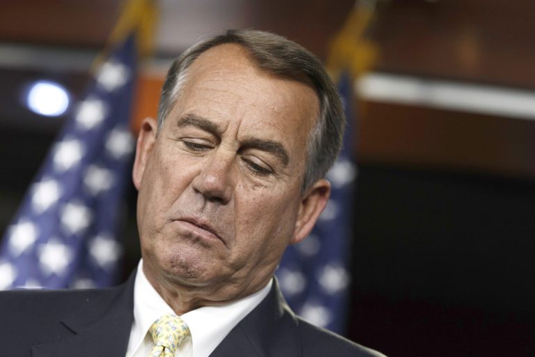 House Republican lawmakers, angry over the GOP's decision to abandon a bill to address the border crisis, crowded around Speaker John Boehner, R-Ohio, in the well of the chamber, demanding to remain in session to resolve the issue. (AP Photo/J. Scott Applewhite)