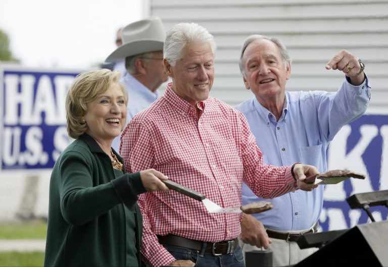 Former Sec. of State Hillary Rodham Clinton, former President Bill Clinton and U.S. Sen. Tom Harkin work the grill during Harkin's annual fundraising Steak Fry, Sunday, Sept. 14, 2014, in Indianola, Iowa. (AP Photo/Charlie Neibergall)