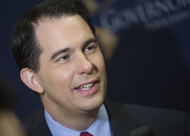 Wisconsin Gov. Scott Walker speaks with a reporter. (AP/Cliff Owen)