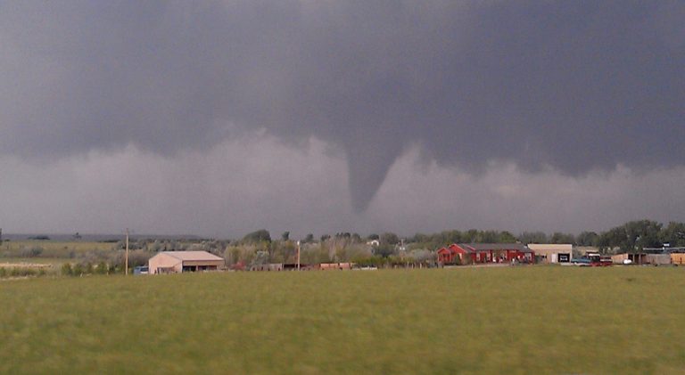   A Thursday, June 7, 2012 photo provided by Andrew Kniss shows a funnel cloud, seen from Kniss's car on Highway 34, near Wheatland, Wyoming. The rare quarter-mile-wide tornado cut a swath across mainly open country in southeastern Wyoming, damaging homes, derailing empty train cars and leaving one person with minor injuries, officials said. The twister was part of a powerful storm system that rolled through parts of Colorado and Wyoming Thursday afternoon and evening, packing heavy rains, high winds and hail. (AP Photo/Andrew Kniss)  