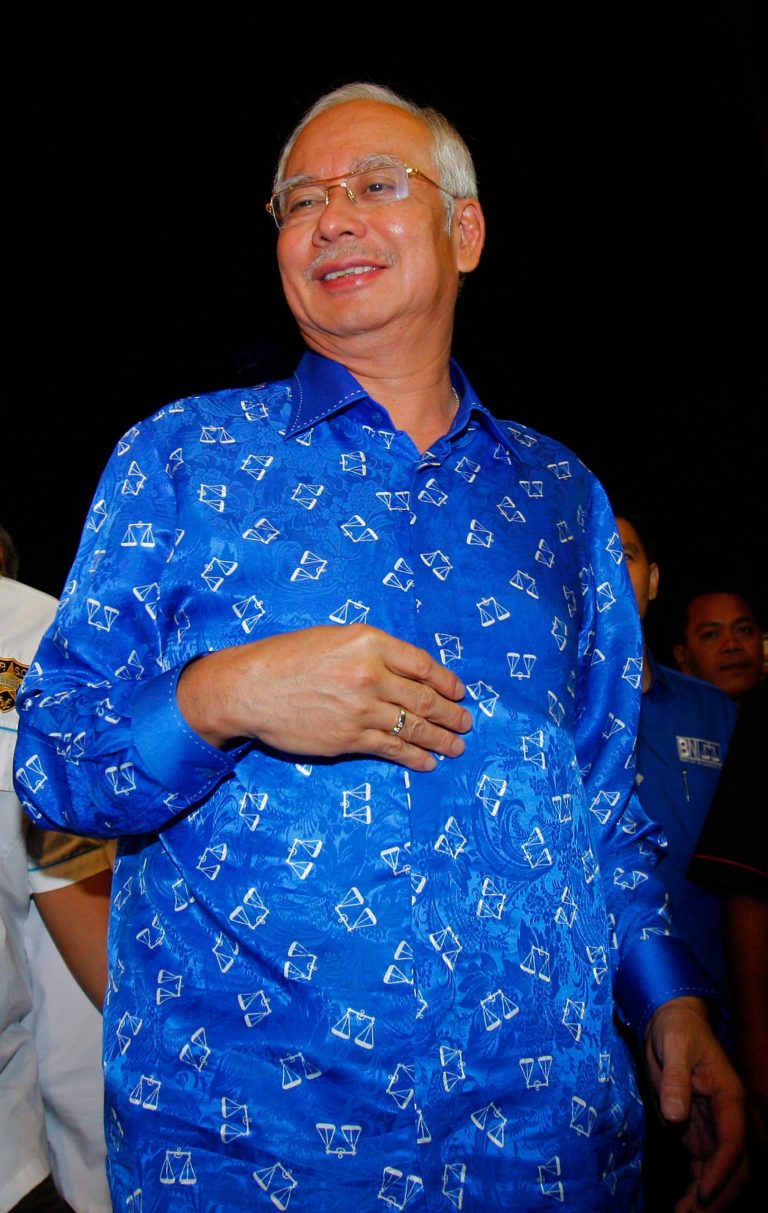 Malaysian Prime Minister Najib Razak arrives at his ruling National Front coalition's headquarters in Kuala Lumpur, Malaysia, Sunday, May 5, 2013. Malaysia's ruling coalition took an early lead in results for national elections Sunday after a record number of voters cast ballots, with some choosing to extend the coalition's 56-year rule and others pressing for an unprecedented victory by an opposition that pledges cleaner government. (AP Photo/Lai Seng Sin)