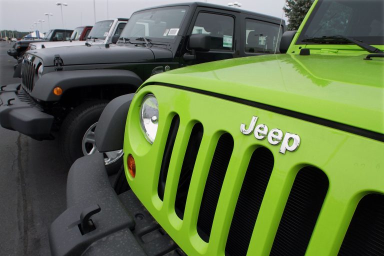 FILE - In this July 1, 2012 file photo, Jeeps sit for sale at a Chrysler dealership in Springfield, Ill. Fiat and Chrysler announced an agreement Saturday, April 19, 2014, that they will build three new Jeep models in China for the local market, the biggest for Jeeps outside the U.S. (AP Photo/Seth Perlman, File)