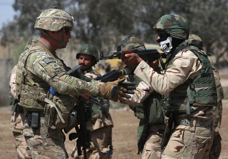 A U.S. Army trainer, instructs Iraqi Army recruits at a military base on April 12, 2015 in Taji, Iraq. U.S. forces, currently operating in 5 large bases throught the country, are training thousands of Iraqi Army combat troops, trying to rebuild a force they had originally trained before the U.S. withdrawal from Iraq in 2010. (Photo by John Moore/Getty Images)