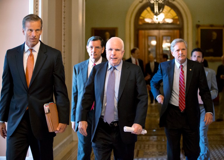Republican Sens., from left, John Thune, R-S.D., John Barrasso, R-Wyo., John McCain, R-Ariz., and John Hoeven, R-N.D., walk from the floor to a closed-door caucus after a compromise between the Democratic majority and the GOP minority on filibuster rules, at the Capitol on Tuesday. (AP/J. Scott Applewhite)