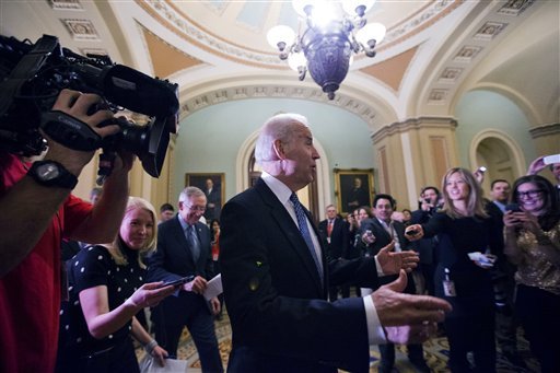 Vice President Joe Biden, center, with Majority Leader Harry Reid, left, of Nevada, arrive for a Senate Democratic caucus meeting about the fiscal cliff, on Capitol Hill Monday, Dec. 31, 2012 in Washington. (AP Photo/Alex Brandon)