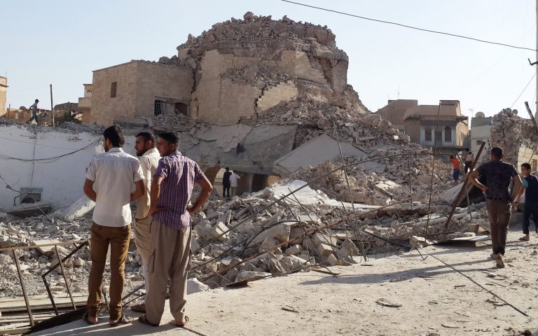 People inspect the destroyed old Mosque of The Prophet Jirjis in central Mosul, Iraq, Sunday, July 27, 2014. The revered Muslim shrine was destroyed on Sunday by militants who overran the city in June and imposed their harsh interpretation of Islamic law. (AP Photo)