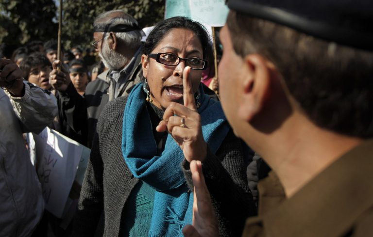   An Indian protester argues with a police officer outside the Delhi Police headquarters as they block a main road during a protest in New Delhi, India, Wednesday, Dec. 19, 2012. The hours-long gang-rape and near fatal beating of a 23-year-old student on a bus in New Delhi triggered outrage and anger across the country Wednesday as Indians demanded action from authorities who have long ignored persistent violence and harassment against women. (AP Photo/Altaf Qadri)  