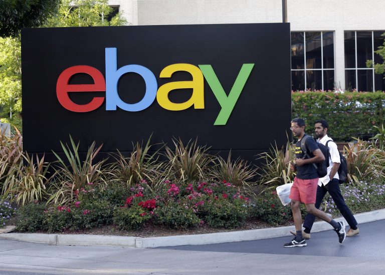 In this June 5, 2014 photo, people walk in front of an eBay Inc. sign at the company's headquarters in San Jose, Calif. EBay Inc. reports quarterly financial results on Wednesday, July 16, 2014. (AP Photo/Marcio Jose Sanchez)