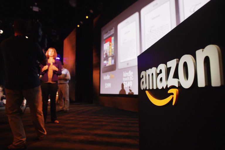 NEW YORK, NY - SEPTEMBER 28:  Members of the media cover the launch of the new Amazon tablet called the Kindle Fire on September 28, 2011 in New York City. The Fire, which will be priced at $199, is an expanded version of the company?s Kindle e-reader that has 8GB of storage and WiFi. The Fire gives users access to streaming video, as well as e-books, apps and music, and has a Web browser. In addition to the Fire, Bezos introduced four new Kindles including a Kindle touch model.  (Photo by Spencer Platt/Getty Images)