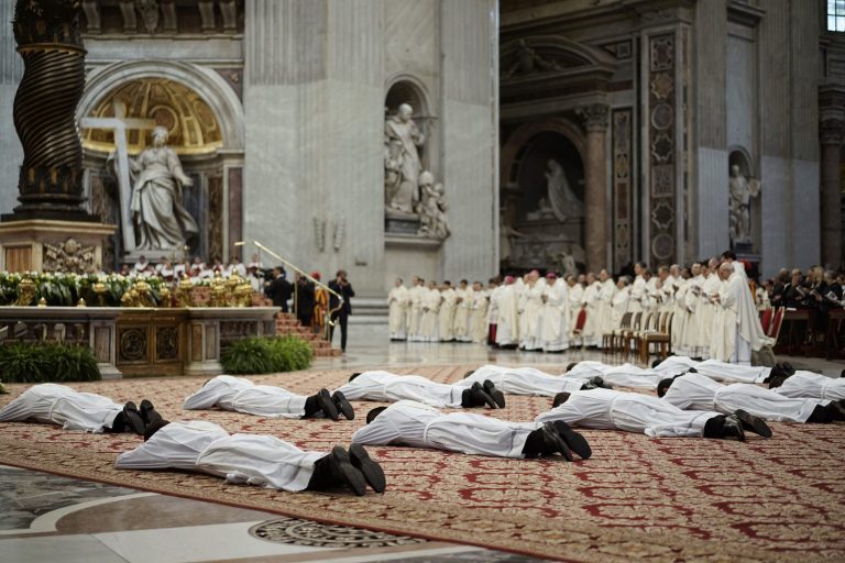 Thirteen new priests lay on the ground during a ceremony in which Pope Francis ordained them, in St. Peter's Basilica at the Vatican,  Sunday, May 11, 2014. (AP Photo/Andrew Medichini)