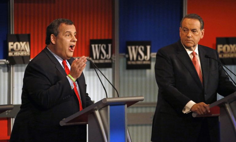 Chris Christie, right, makes a point as Mike Huckabee listens during Republican presidential debate. (AP Photo/Morry Gash)