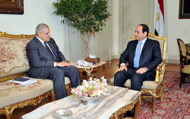 This photo released by Egypt's official Middle East News Agency (MENA) shows Prime Minister Ibrahim Mehleb, left, meeting with President Abdel-Fattah el-Sissi at the presidential palace in Cairo, Egypt, Thursday, June 12, 2014. (AP Photo/MENA)