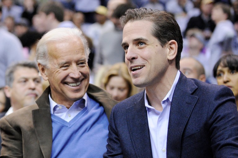 Vice President Joe Biden, left, and his son R. Hunter Biden watch a Duke/Georgetown college basketball game, Saturday, Jan. 30, 2010, in Washington. (AP Photo/Nick Wass)