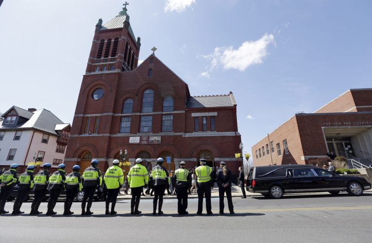 Medford and Somerville police line the street outside St. Joseph's Church in Medford, Mass. Monday, April 22, 2013 for the funeral of Boston Marathon bomb victim Krystle Campbell, 29. (AP Photo/Elise Amendola)