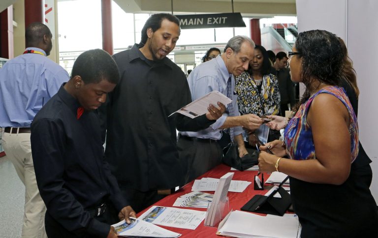 In this photo taken Tuesday, Aug. 19, 2014, job seeker Stephen Watson, of Fort Lauderdale, second from left, reviews the job qualifications during a job fair in Sunrise. Fla. The Labor Department reports on job openings and labor turnover in July on Tuesday, Sept. 9, 2014. (AP Photo/Alan Diaz)
