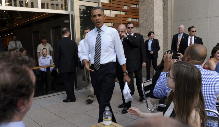 President Barack Obama greets people after picking up lunch at Taylor Gourmet sandwich shop near the White House in Washington, Friday, Oct. 4, 2013. (AP Photo/Susan Walsh)