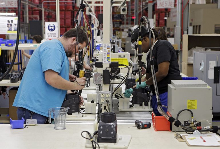 In this April 15, 2014 photo, workers assemble blender bases at the Vitamix  manufacturing facility in Strongsville, Ohio. The Institute for Supply Management, a trade group of purchasing managers, issues its index of manufacturing activity for April on Thursday, May 1, 2014. (AP Photo/Mark Duncan)