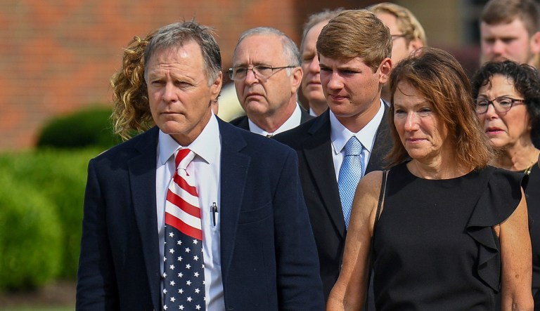 Fred and Cindy Warmbier watch as their son Otto, is placed in a hearse after his funeral. Otto Warmbier, a 22-year-old University of Virginia undergraduate student who was sentenced in March 2016 to 15 years in prison in North Korea, died in June, days after returning to the United States. (AP Photo/Bryan Woolston)