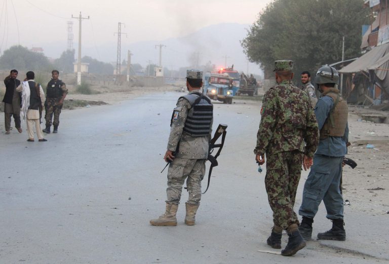 Afghan security forces inspect the site of a suicide attack in Jalalabad, east of Kabul, Afghanistan, Saturday, Aug. 30, 2014. A suicide bomber in a truck blew himself up at an intelligence headquarters in eastern Afghanistan on Saturday, setting off an intense firefight with security forces, officials said. (AP Photo)