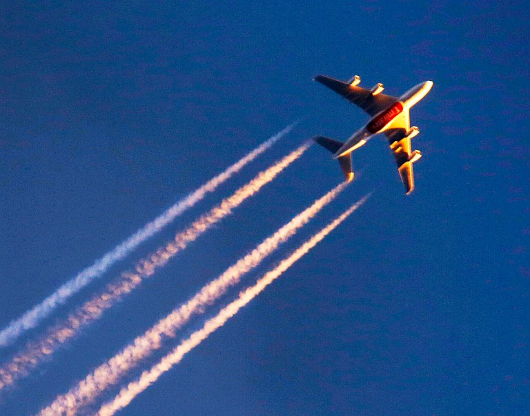 The four-engine aircraft of Emirates airline is illuminated by last rays of the sun as it flies over Frankfurt, Germany on March 10. As Persian Gulf airlines Etihad Airways, Emirates, and Qatar Airways have expanded operations into the U.S. in recent years, some of the major American carriers took notice. (AP Photo/Michael Probst)