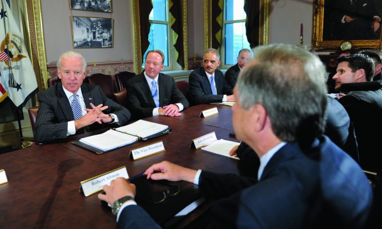 Vice President Joe Biden, left, with Attorney General Eric Holder, second from right, speaks during a meeting with representatives from the video game industry in the Eisenhower Executive Office Building on the White House complex in Washington, Friday, Jan. 11, 2013. Biden is holding a series of meetings this week as part of the effort he is leading to develop policy proposals in response to the Newtown, Conn., school shooting. Entertainment Software Association President Mike Gallagher sits between Biden and Holder. ZeniMax Media CEO Robert Altman sits in the foreground. (AP Photo/Susan Walsh) . (AP Photo/Susan Walsh)