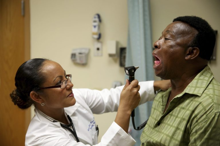Felue Chang, newly insured under the Affordable Care Act, receives a checkup from Dr. Peria Del Pino-White on April 15 in Hollywood, Florida. (Getty images / Joe Raedle)